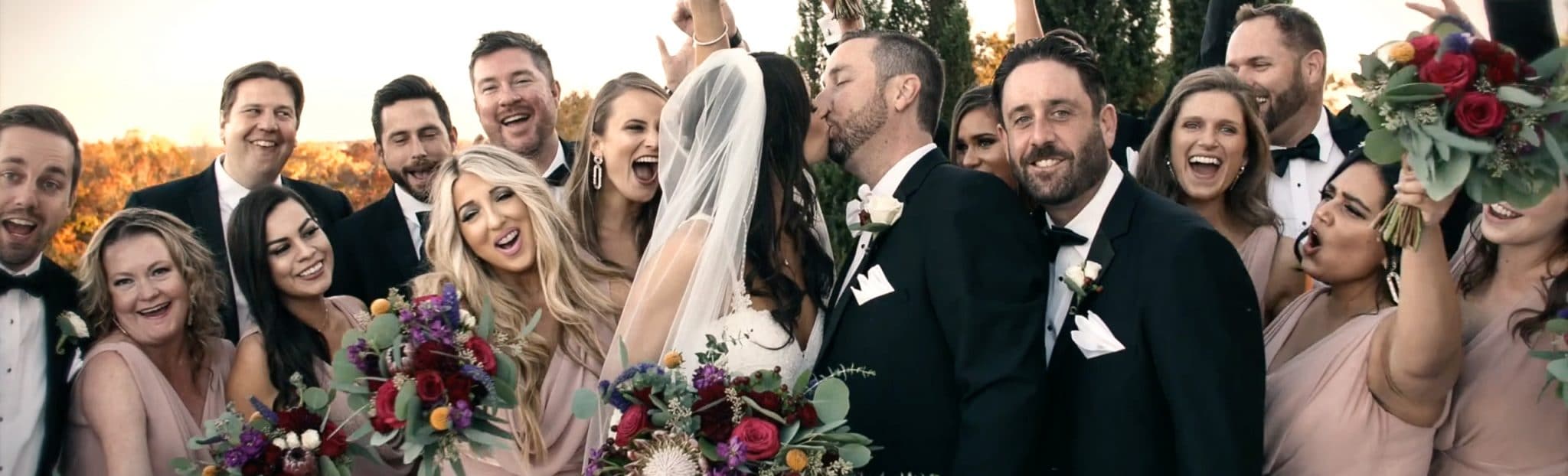 Bride & Groom Kissing With Bridemaids